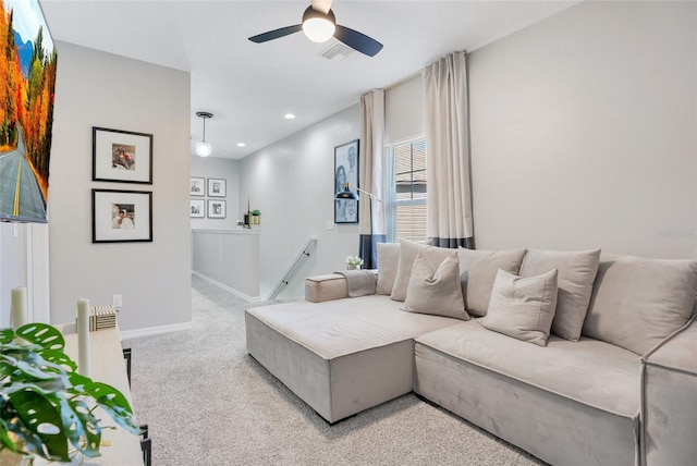 carpeted living room with ceiling fan