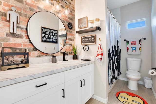 bathroom featuring a shower with shower curtain, hardwood / wood-style floors, vanity, and toilet