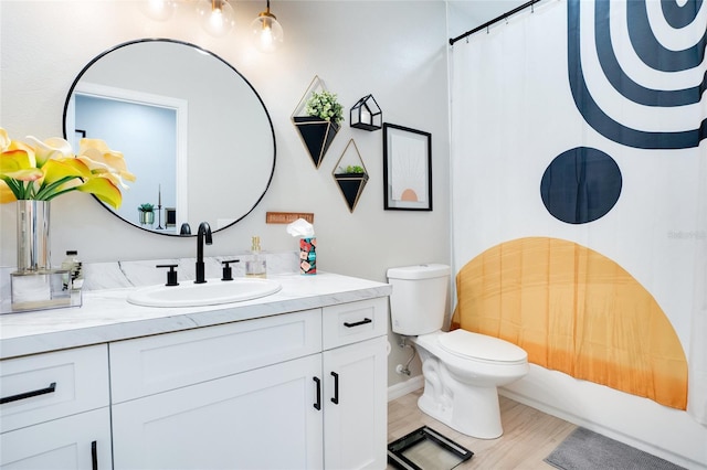 full bathroom with shower / tub combo, vanity, hardwood / wood-style flooring, and toilet