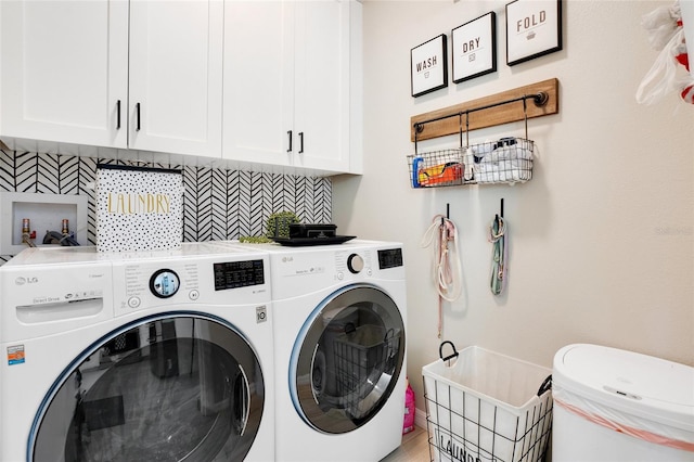 laundry area with washer and dryer and cabinets