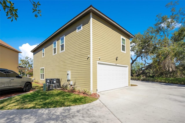 view of property exterior featuring central air condition unit and a garage