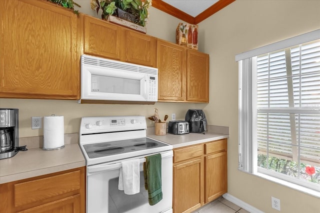 kitchen featuring white appliances, light tile patterned floors, and a healthy amount of sunlight