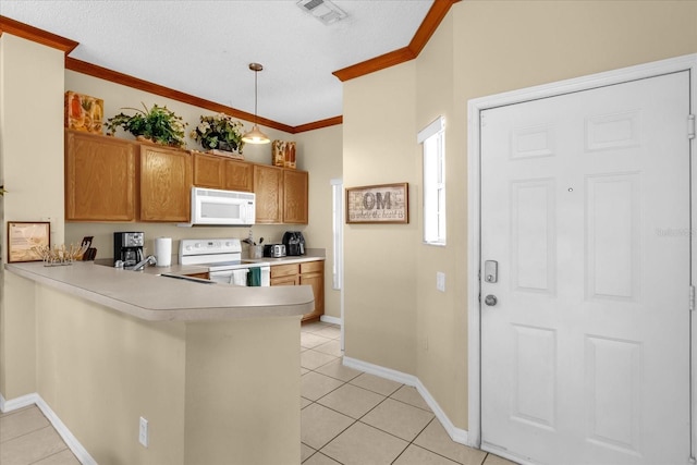 kitchen with light tile patterned floors, kitchen peninsula, white appliances, and pendant lighting