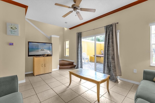 living room featuring ceiling fan, light tile patterned flooring, crown molding, and a textured ceiling