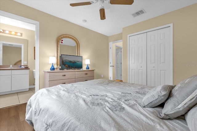 bedroom with ceiling fan, a closet, and light hardwood / wood-style flooring