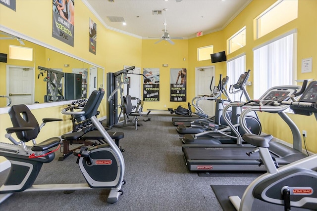 workout area with ceiling fan, a high ceiling, and crown molding