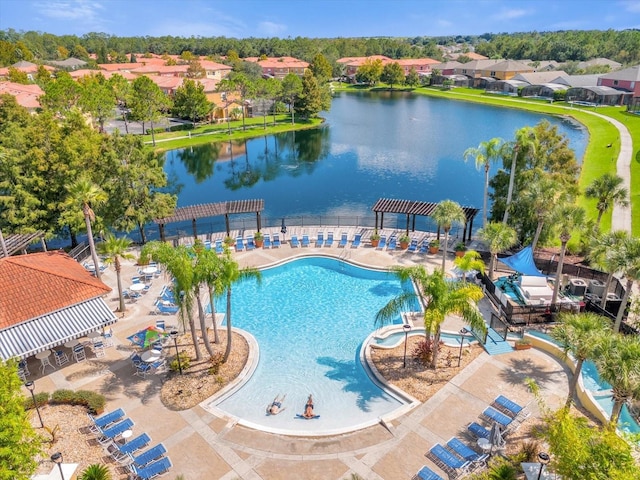 view of pool with a patio area and a water view