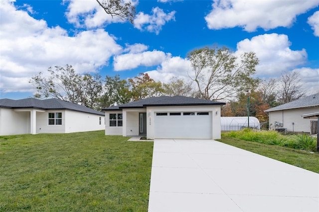 view of front of house featuring a garage and a front lawn