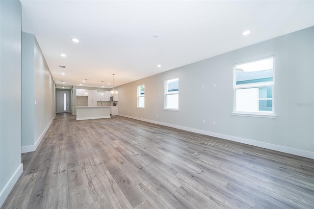 unfurnished living room featuring light hardwood / wood-style flooring