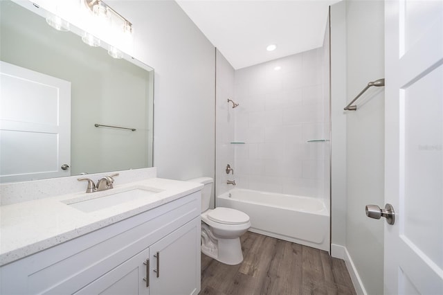 full bathroom with toilet, tub / shower combination, vanity, and hardwood / wood-style floors