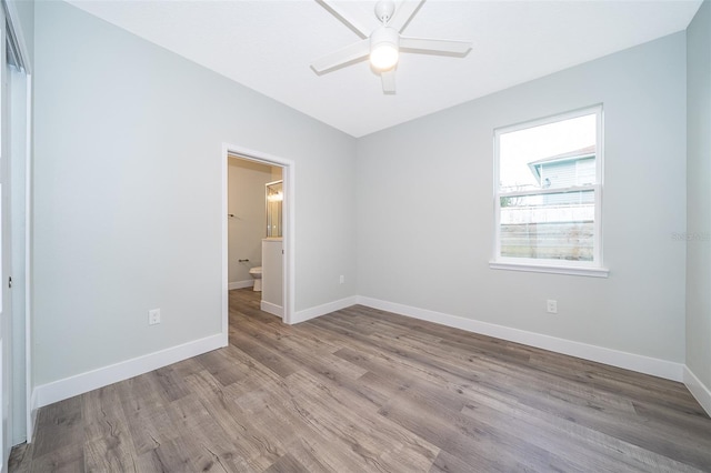 unfurnished bedroom featuring connected bathroom, ceiling fan, and light hardwood / wood-style flooring