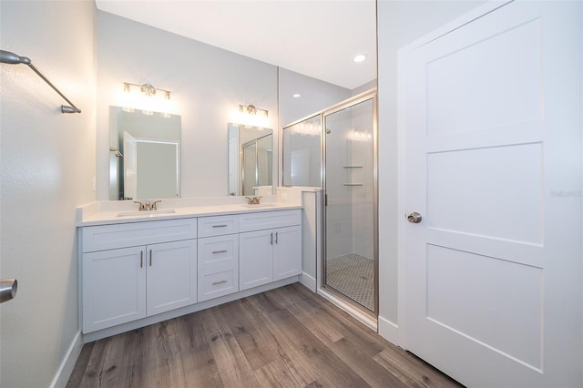 bathroom featuring wood-type flooring, vanity, and an enclosed shower