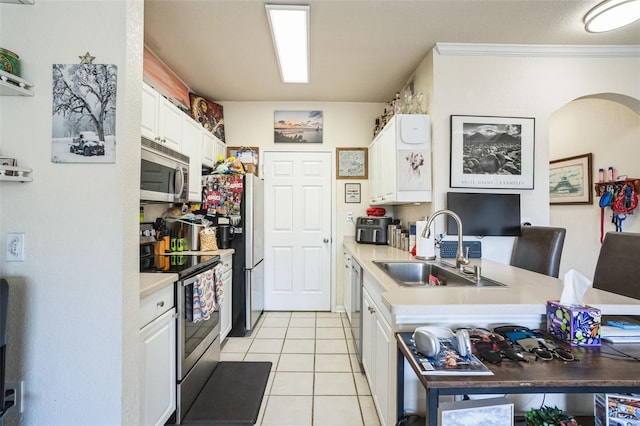 kitchen featuring stainless steel appliances, crown molding, white cabinets, light tile patterned flooring, and sink