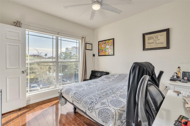 bedroom with ceiling fan and hardwood / wood-style flooring