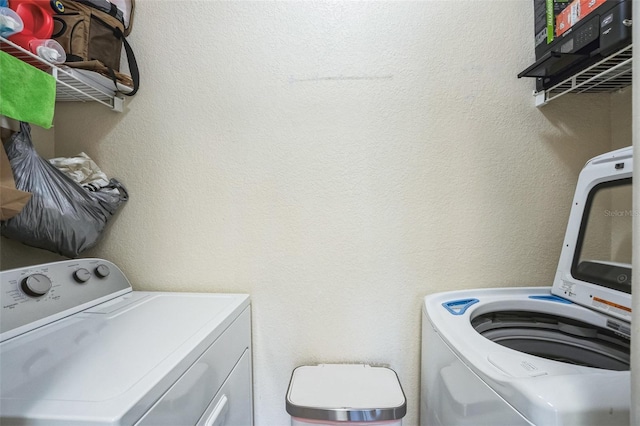 washroom featuring washing machine and clothes dryer