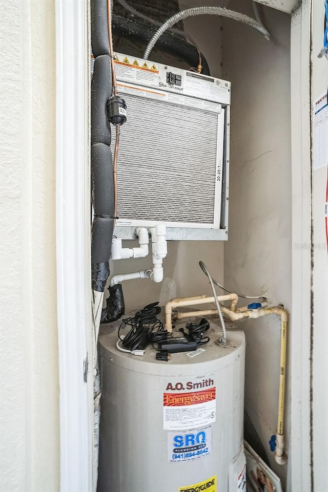 utility room featuring water heater