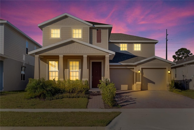 view of front of home featuring a porch and a garage