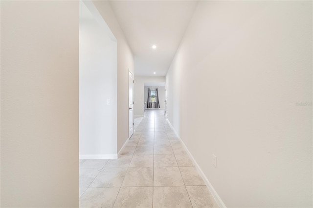 hall with light tile patterned floors