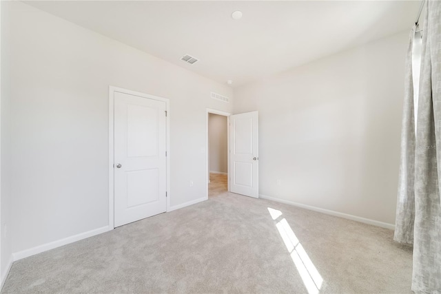 unfurnished bedroom with light colored carpet