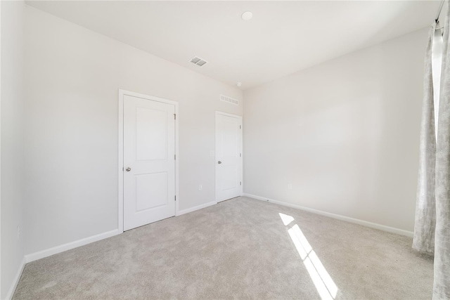 unfurnished bedroom featuring light colored carpet