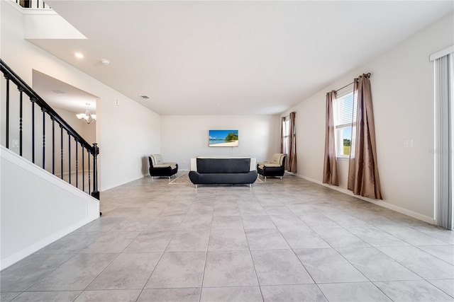 unfurnished room featuring a notable chandelier and light tile patterned flooring