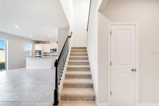 stairway with tile patterned flooring