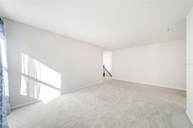 spare room featuring light colored carpet