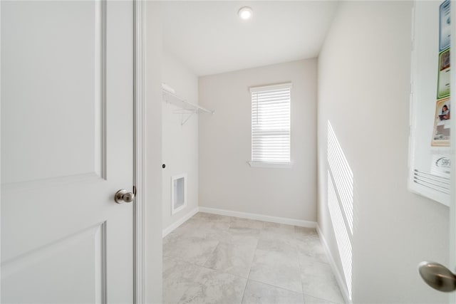 spacious closet with light tile patterned floors