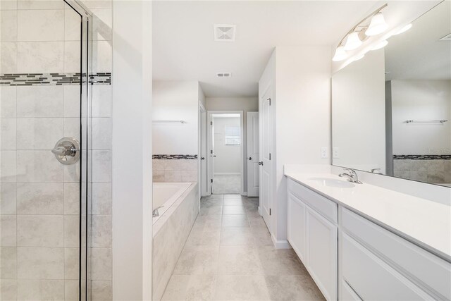 bathroom featuring vanity, tile patterned floors, and separate shower and tub