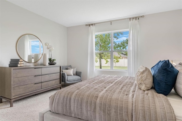 bedroom featuring light colored carpet