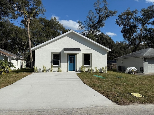 view of front of property featuring a front lawn and cooling unit