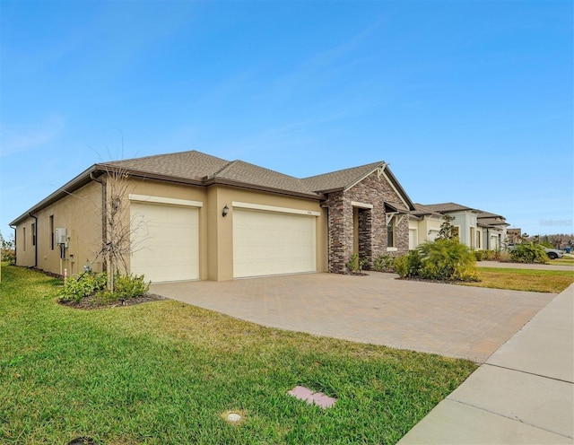 view of front facade with a garage and a front lawn