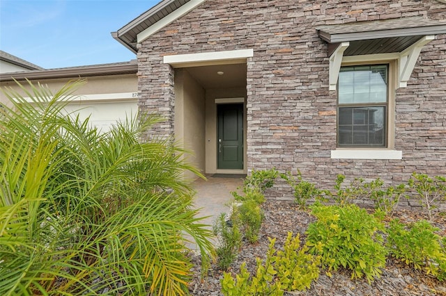 view of exterior entry featuring a garage