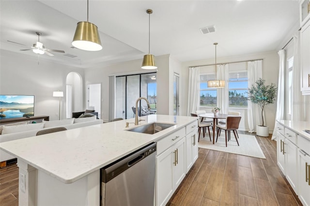 kitchen featuring hanging light fixtures, dishwasher, sink, and white cabinetry