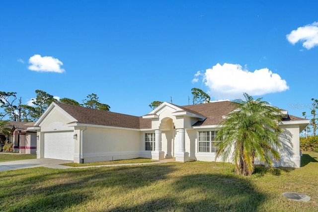 ranch-style house featuring a garage, a front yard, concrete driveway, and stucco siding