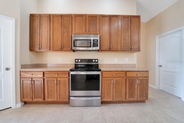 kitchen featuring light tile patterned floors and appliances with stainless steel finishes