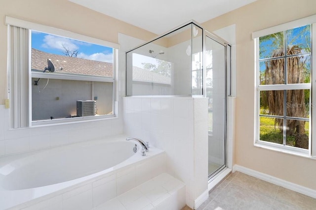 bathroom with separate shower and tub and tile patterned flooring