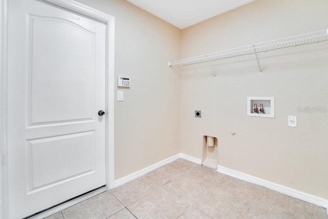 laundry room with electric dryer hookup, gas dryer hookup, hookup for a washing machine, and light tile patterned flooring