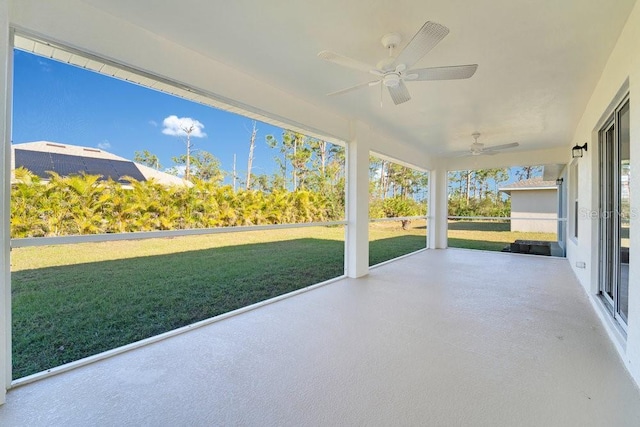 unfurnished sunroom with ceiling fan