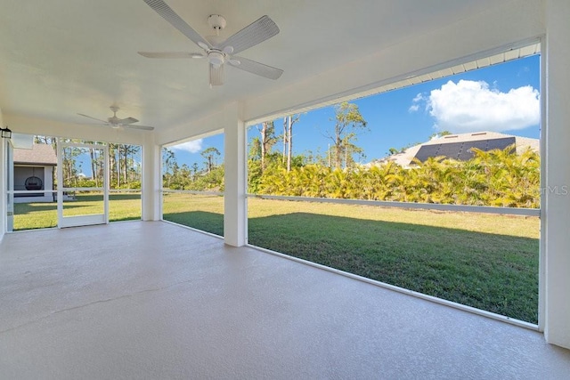 unfurnished sunroom with ceiling fan and plenty of natural light