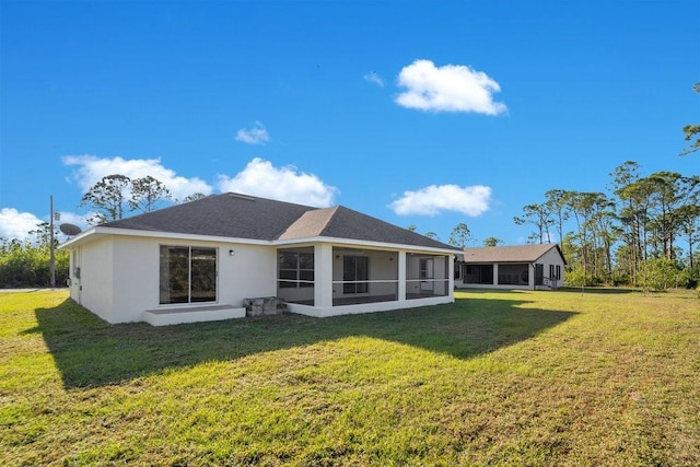 back of house with a sunroom and a lawn