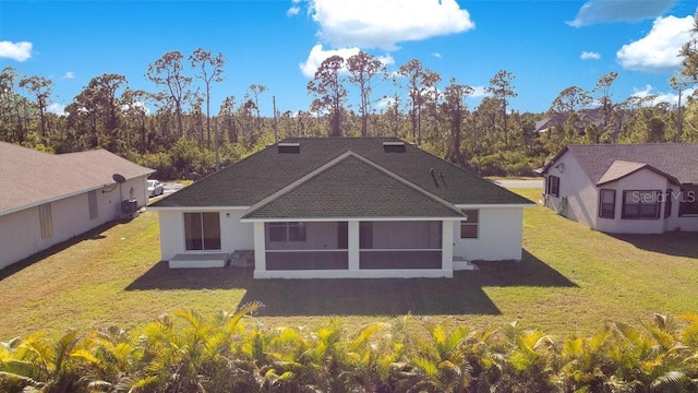 back of house with a lawn and a sunroom