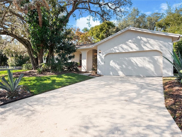 single story home featuring a garage and a front lawn