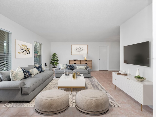 living room featuring light tile patterned floors and a textured ceiling