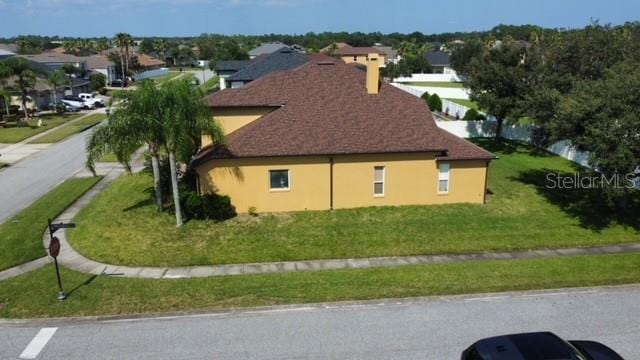 view of side of home featuring a yard