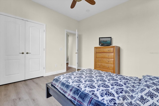 bedroom featuring ceiling fan, hardwood / wood-style floors, and a closet