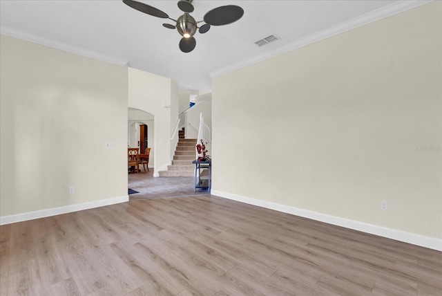 unfurnished living room with ornamental molding, light hardwood / wood-style floors, and ceiling fan