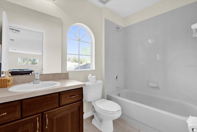 full bathroom with tiled shower / bath, vanity, toilet, and tile patterned floors