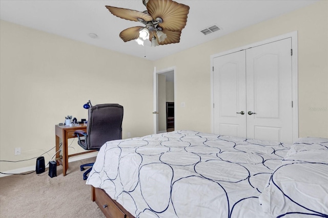 carpeted bedroom featuring ceiling fan and a closet