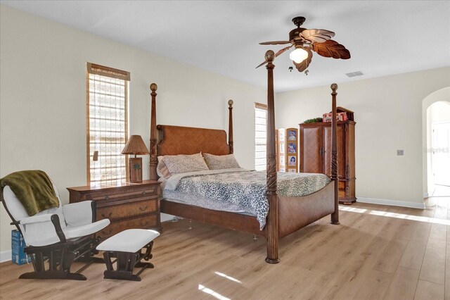 bedroom with multiple windows and light hardwood / wood-style flooring